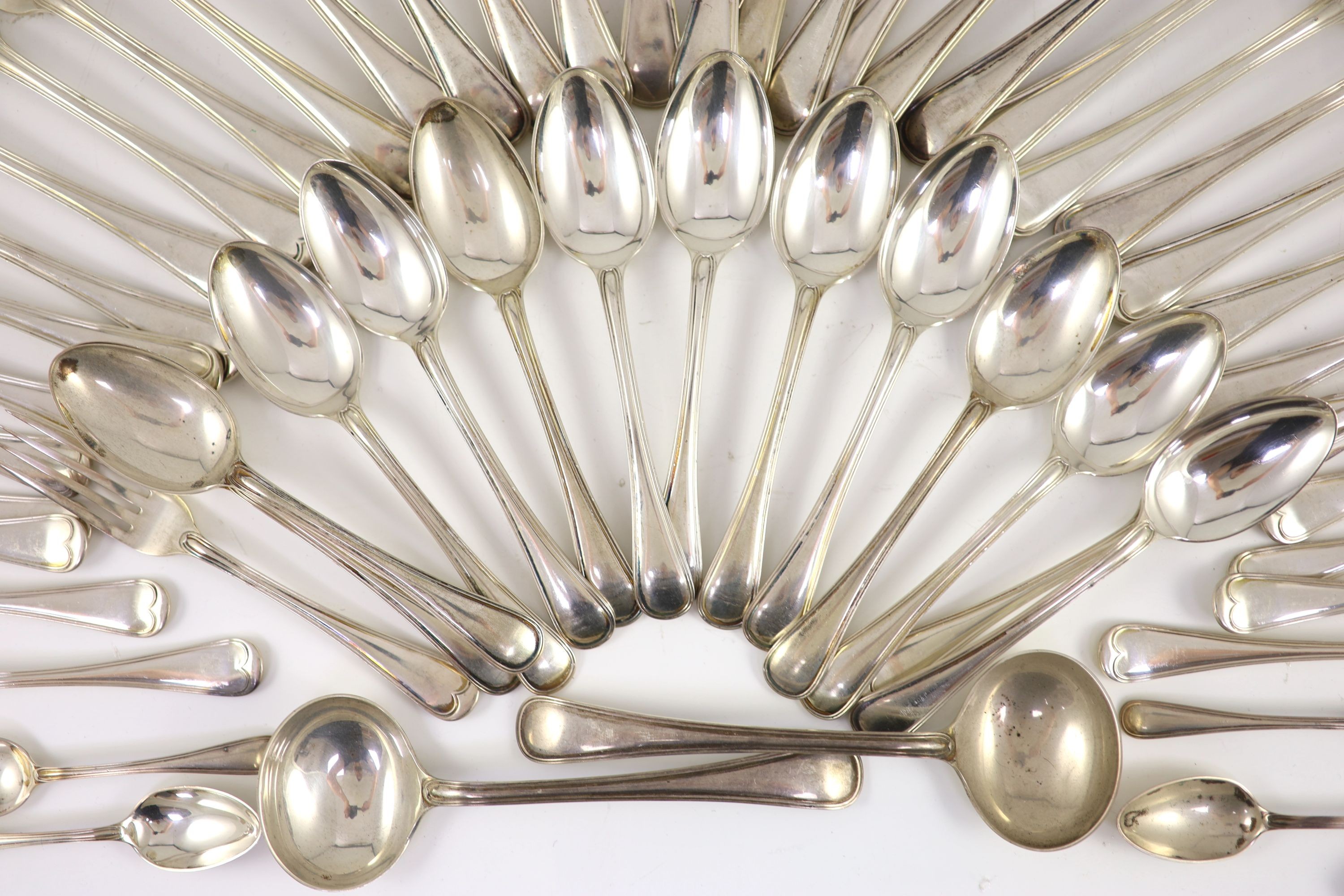 A part canteen of Edwardian silver Old English double struck thread pattern flatware for twelve by John Round & Son Ltd